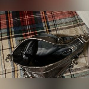Metallic sliver coach purse.